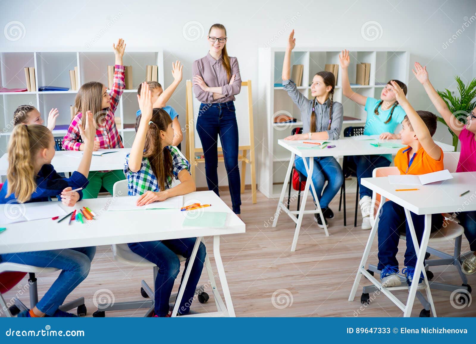 students-raise-hands-class-their-to-answer-question-89647333.jpg